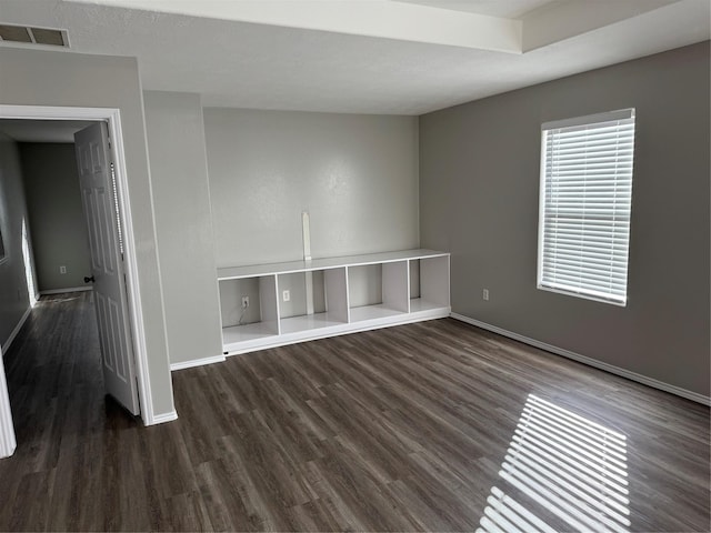 spare room with dark wood-type flooring