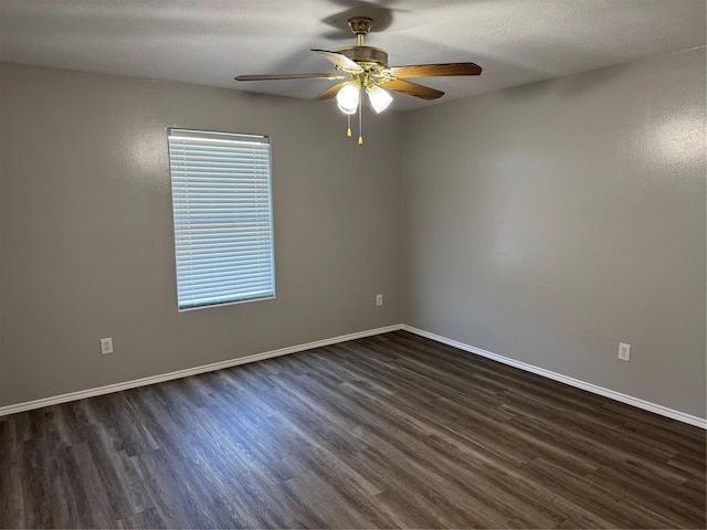 unfurnished room featuring ceiling fan and dark wood-type flooring