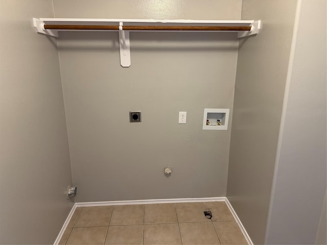 washroom featuring hookup for an electric dryer, hookup for a gas dryer, light tile patterned floors, and hookup for a washing machine