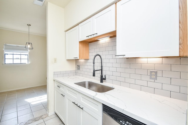 kitchen featuring light tile patterned floors, a sink, visible vents, white cabinets, and decorative backsplash