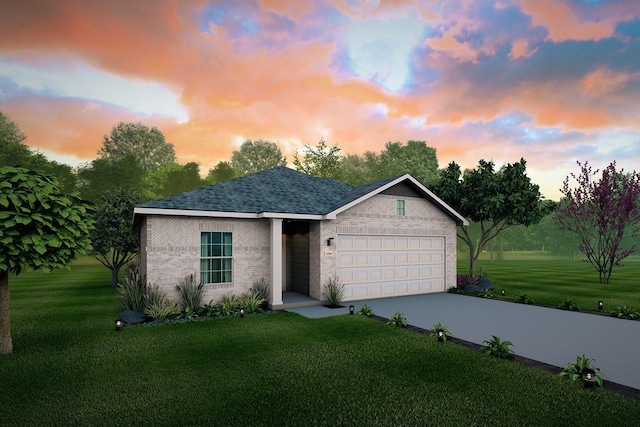 view of front of house with a yard and a garage