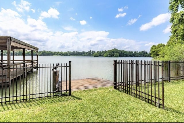 view of dock featuring a water view and a yard