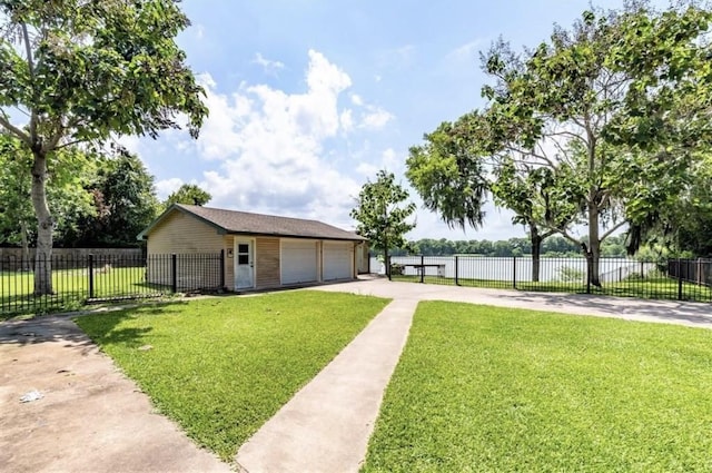 view of front of property featuring a front yard, an outdoor structure, and a garage