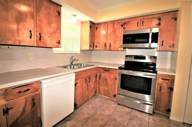 kitchen with sink, crown molding, decorative backsplash, light tile patterned floors, and appliances with stainless steel finishes