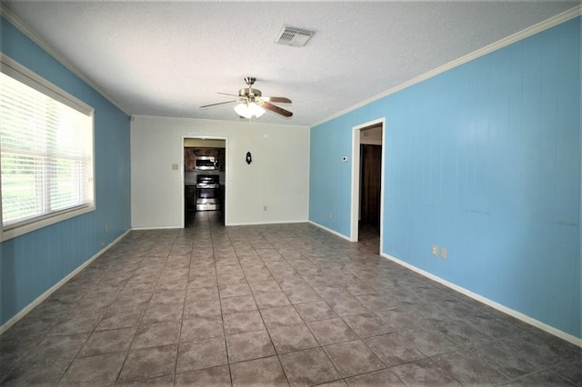 tiled spare room with a textured ceiling, ceiling fan, and crown molding