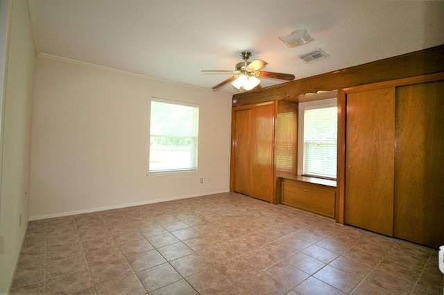 unfurnished bedroom featuring ceiling fan and ornamental molding