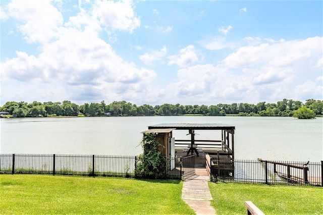 dock area featuring a water view and a lawn