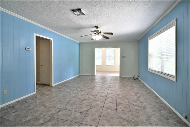 unfurnished room featuring ceiling fan, crown molding, and light tile patterned flooring