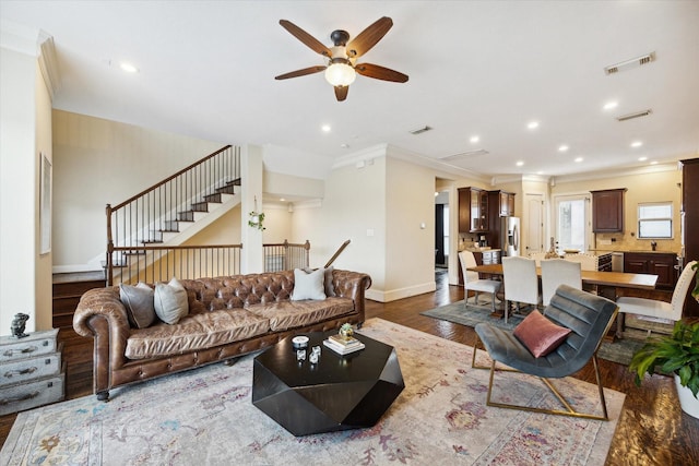 living room featuring ceiling fan, crown molding, and dark hardwood / wood-style floors