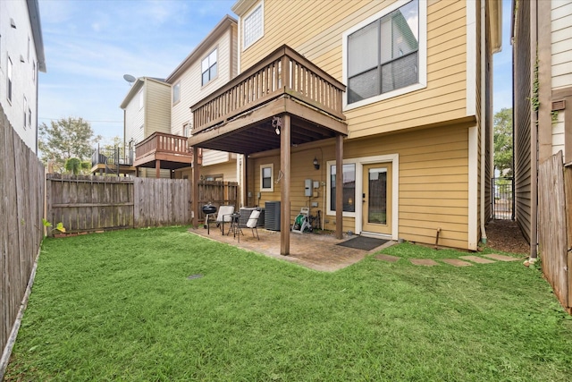 back of property with a lawn, a patio area, cooling unit, and a deck