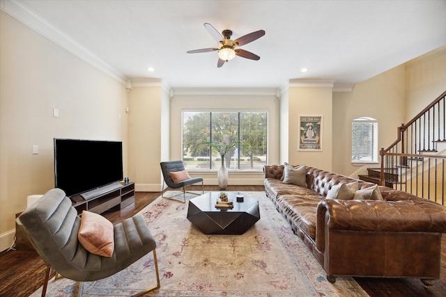 living room featuring wood-type flooring, ceiling fan, and crown molding