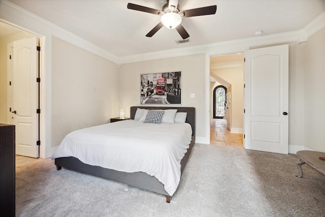 bedroom featuring light carpet, ceiling fan, and ornamental molding