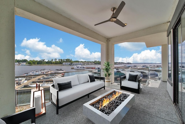 view of patio with a water view, an outdoor living space with a fire pit, and ceiling fan