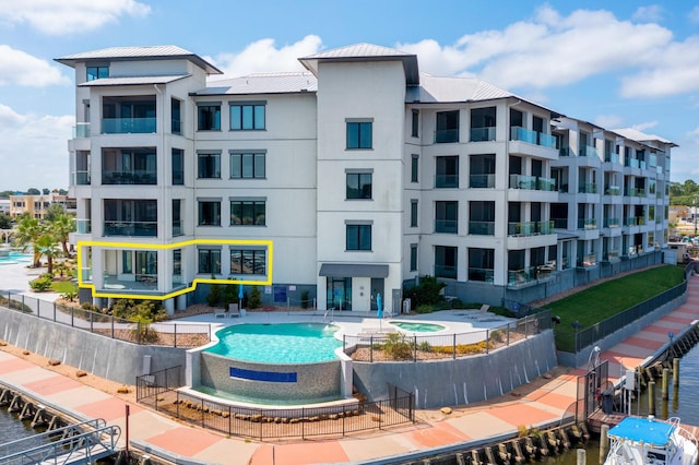 view of property featuring a community pool and a water view