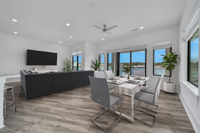 dining area with hardwood / wood-style flooring and ceiling fan