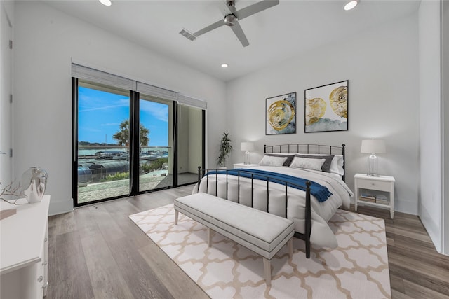 bedroom featuring wood-type flooring, access to outside, and ceiling fan