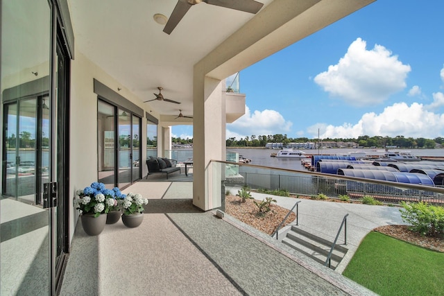 view of patio featuring a water view and ceiling fan