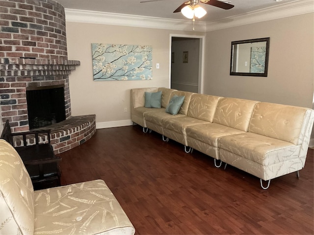 living room featuring dark hardwood / wood-style floors, a brick fireplace, ceiling fan, and crown molding