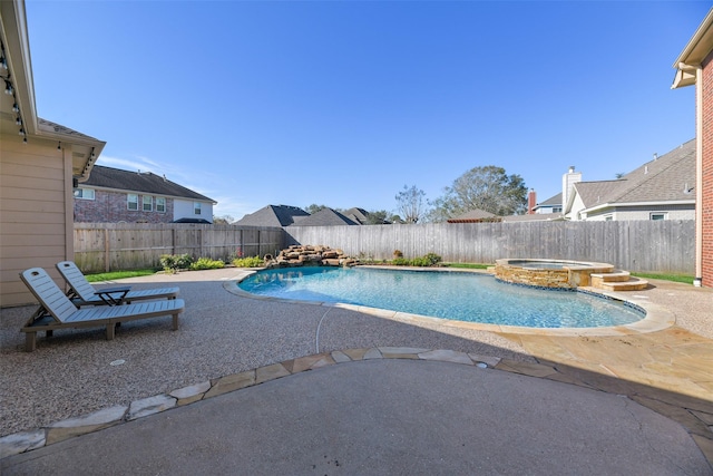 view of pool with an in ground hot tub and a patio