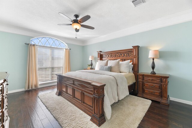 bedroom featuring ceiling fan, dark hardwood / wood-style flooring, ornamental molding, and a textured ceiling