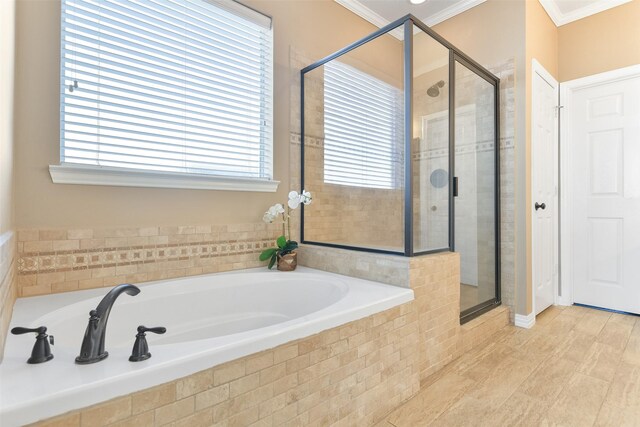 bathroom with independent shower and bath and ornamental molding