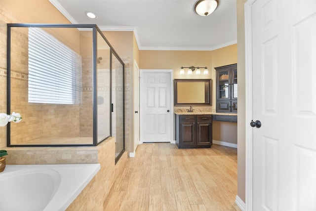 bathroom with hardwood / wood-style flooring, vanity, crown molding, and independent shower and bath