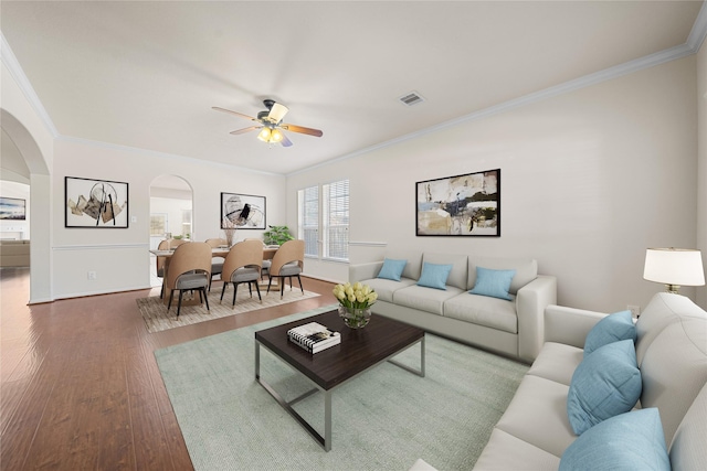 living room featuring ceiling fan, dark hardwood / wood-style floors, and ornamental molding