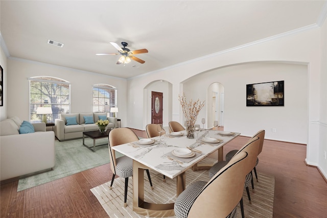 dining area with ceiling fan, crown molding, and hardwood / wood-style flooring