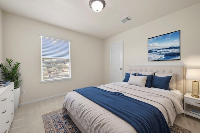 bedroom featuring light carpet