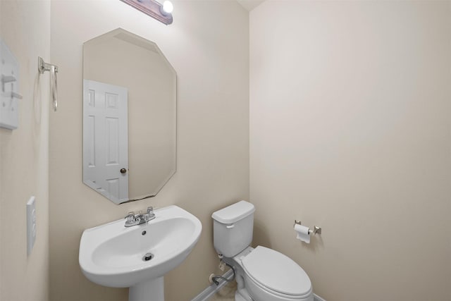 bathroom featuring toilet and sink