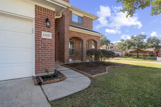 entrance to property featuring a lawn