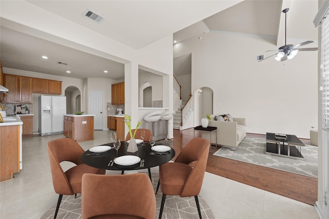 dining area with ceiling fan and light tile patterned floors