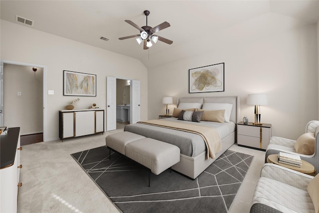 carpeted bedroom featuring ceiling fan, ensuite bath, and lofted ceiling