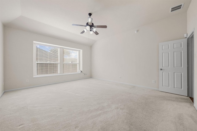 spare room featuring ceiling fan, lofted ceiling, and light colored carpet