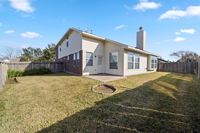 back of property featuring a patio area and a yard