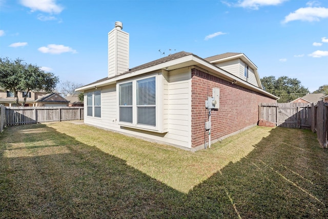 back of property featuring a lawn