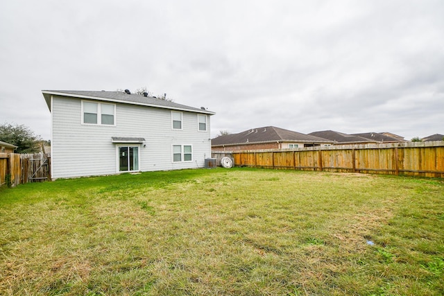 rear view of property with a yard