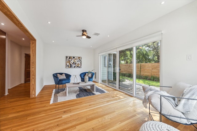 sitting room with light wood-type flooring and ceiling fan