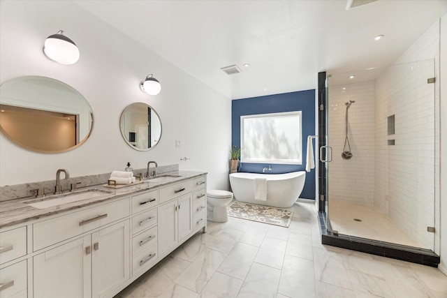 full bathroom featuring vanity, toilet, and independent shower and bath