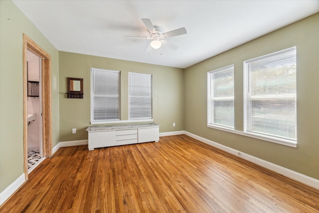 unfurnished room with light wood-type flooring and ceiling fan