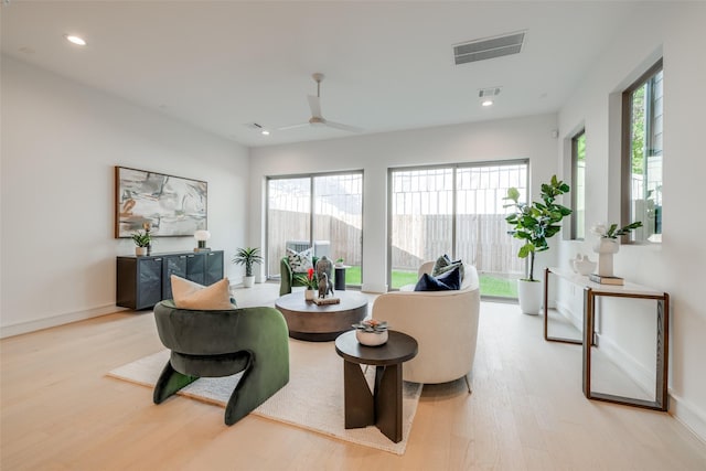 living room with ceiling fan and light hardwood / wood-style floors