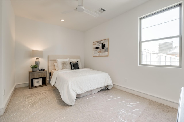 bedroom featuring ceiling fan and light carpet