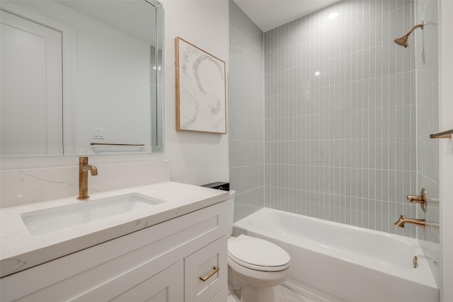 full bathroom featuring vanity, toilet, and tiled shower / bath