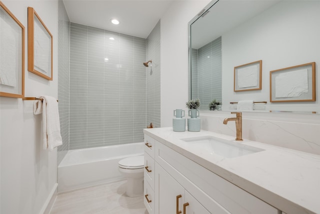 full bathroom with vanity, toilet, and tiled shower / bath