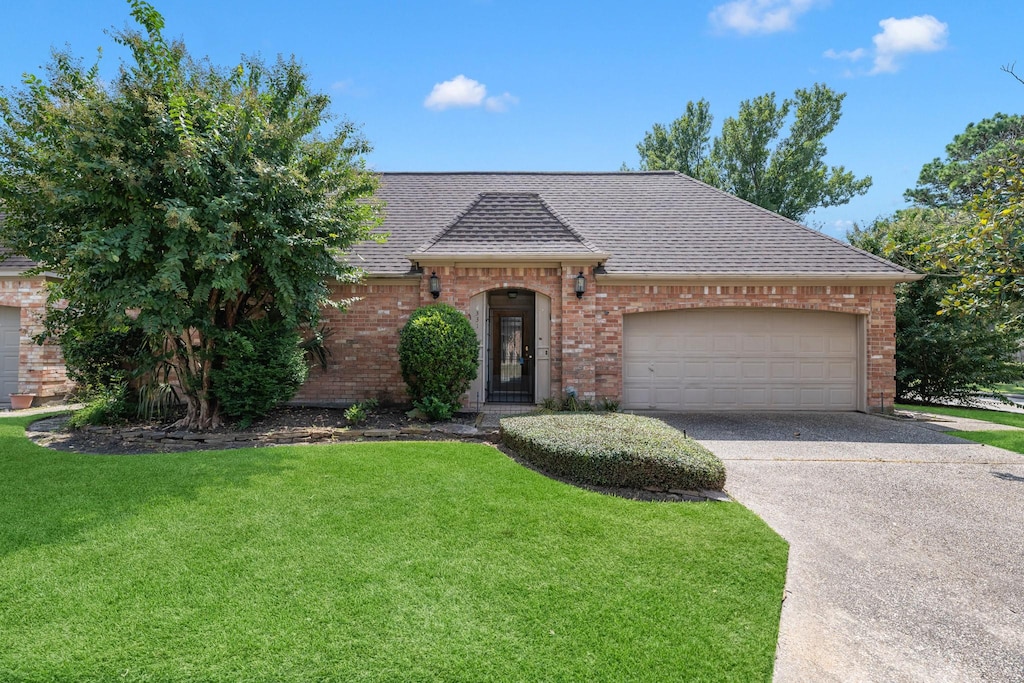 331 Champions Colony Iii, Houston, TX 77069 - view of front facade with a garage and a front lawn