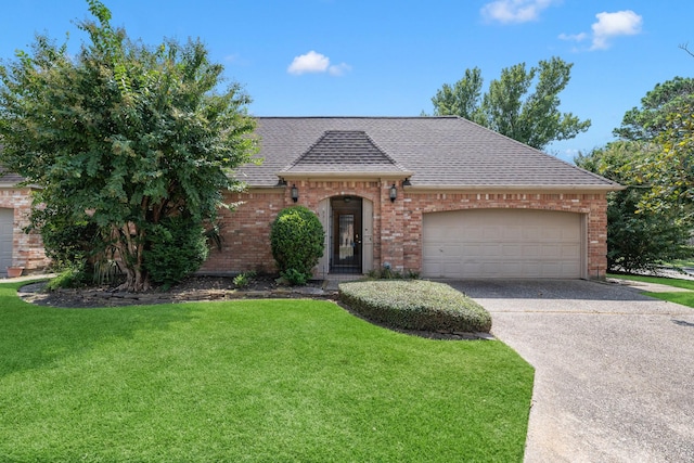 view of front facade with a garage and a front lawn