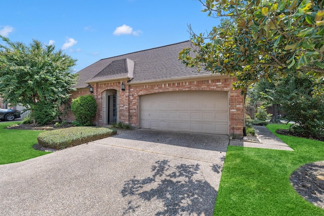 view of front of home with a garage and a front lawn