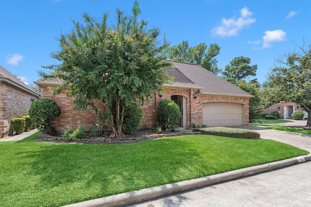 view of front of home with a garage and a front lawn