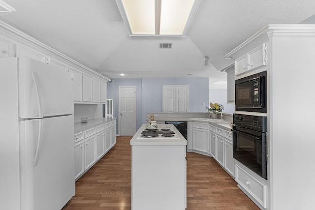 kitchen with a kitchen island, dark hardwood / wood-style flooring, kitchen peninsula, white cabinets, and black appliances