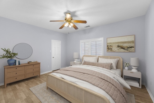 bedroom with light hardwood / wood-style floors and ceiling fan